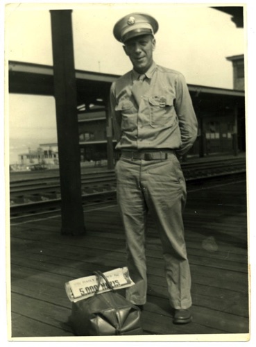 Pvt Bernard Schilling at unknown train station during WWII. 1942? CHS-010163